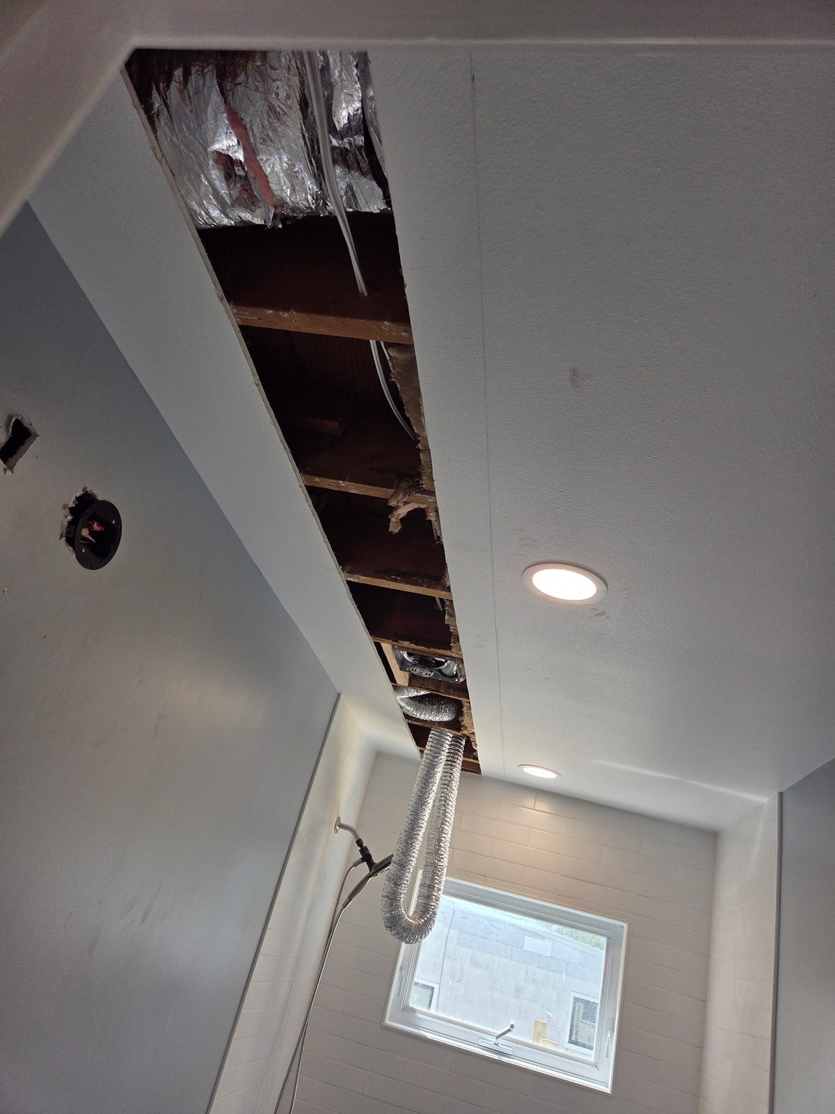 A ceiling opened up with the joists exposed after water damage